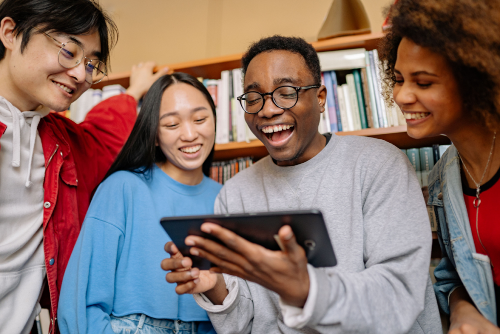 Students using a tablet together in a classroom setting