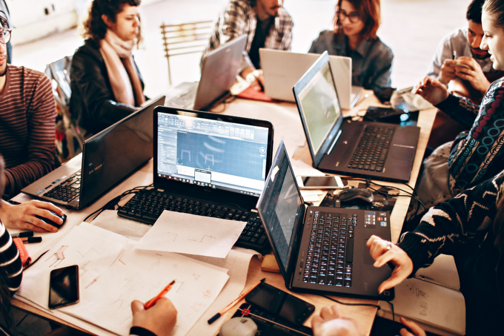 Software developers working on a laptop in an office