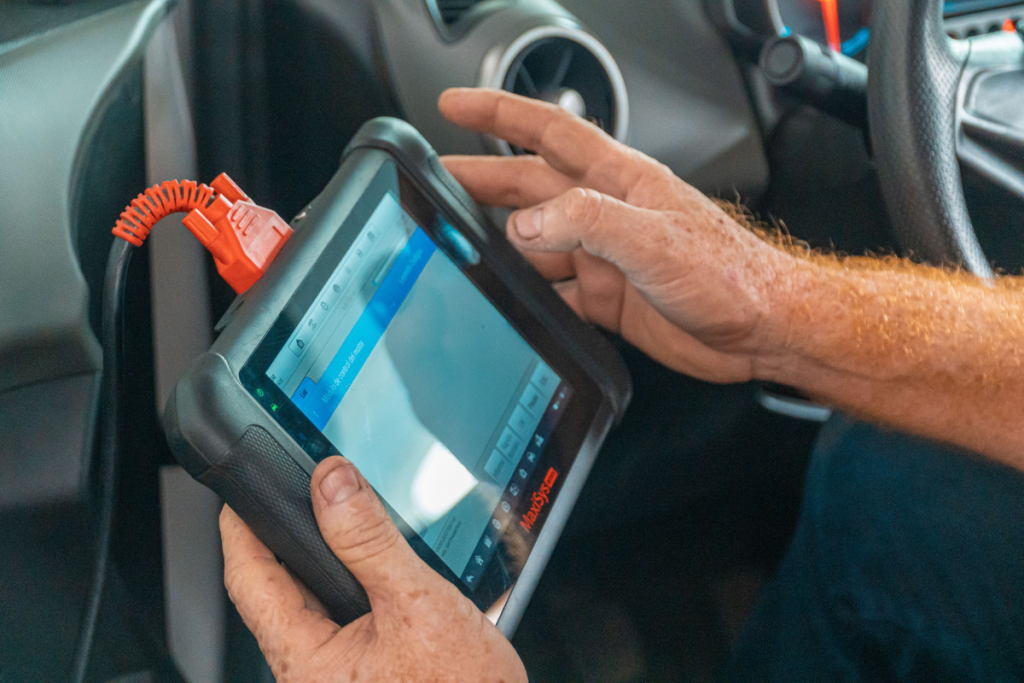 Field technician using a rugged tablet during an installation