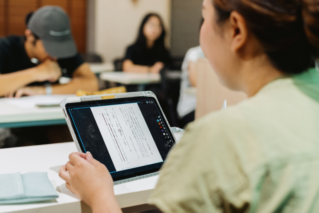 Students using a tablet together during a classroom lesson