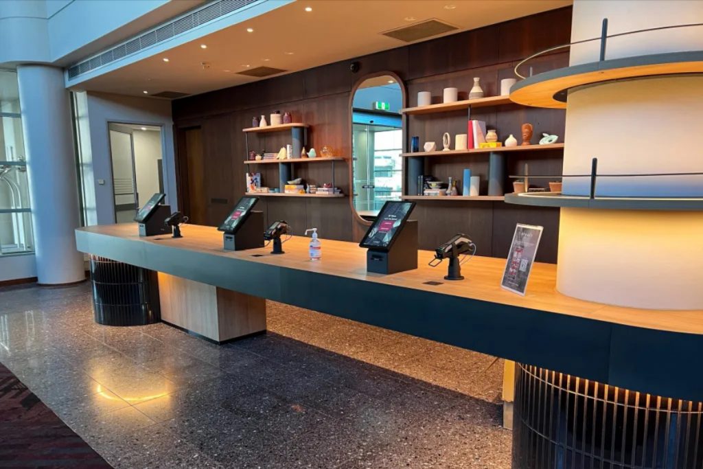 Hotel guest using a self check-in kiosk in the lobby