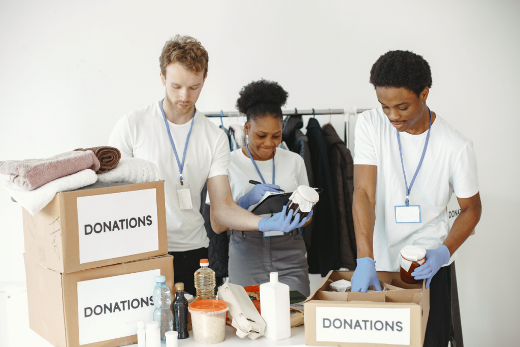 Volunteer using a tablet to manage donations during a fundraising event